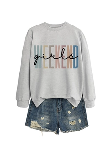 Flat lay of gray long sleeve sweatshirt with rainbow Weekend Girls print and ripped denim shorts