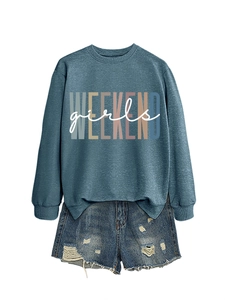 Detail of Weekend Girls lettering on loose crewneck sweatshirt with denim shorts