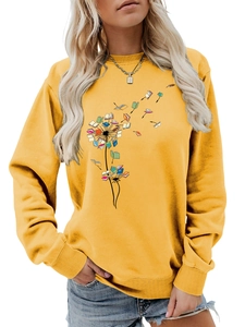 Close-up of yellow long sleeve sweatshirt featuring creative dandelion book print detail