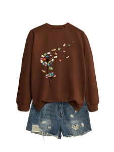Detail of dandelion and colorful books print on a coffee-colored long sleeve sweatshirt