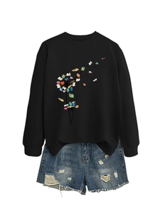Detail of black sweatshirt with dandelion book print and distressed denim shorts