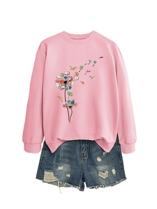 Flat lay of pink long sleeve sweatshirt with dandelion book print and ripped denim shorts