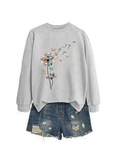 Detail of grey sweatshirt with creative dandelion book print and ripped denim shorts