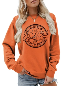 Close-up of orange sweatshirt with What Happens in Book Club slogan print