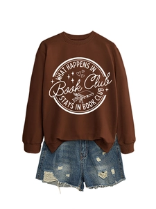 Detail of What Happens in Book Club text on brown sweatshirt with denim shorts