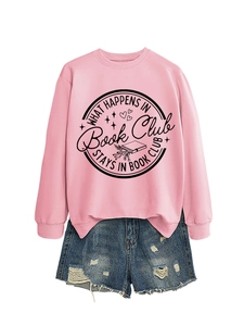 Close-up of pink crewneck sweatshirt with 'What happens in book club' print and denim shorts