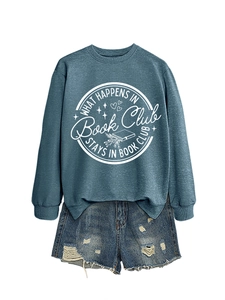 Detail of What Happens in Book Club text print on navy cotton sweatshirt with denim shorts