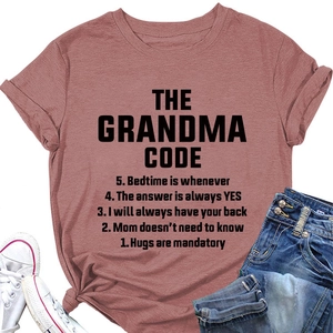 Flat lay of pink cotton T-shirt featuring artistic 'Grandma Rules' text and crew neck