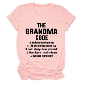 Detail of pink cotton t-shirt featuring THE GRANDMA CODE graphic print on flat lay