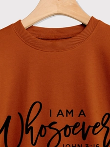 Close-up of ribbed neckline and printed lettering on caramel crewneck sweatshirt