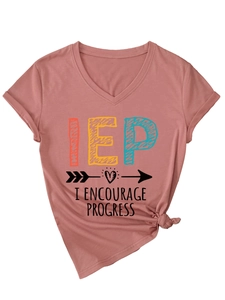 Detail of V-neck dusty rose t-shirt featuring artistic IEP text and knot hem detail