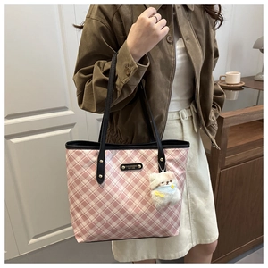 Pink plaid tote bag detail with fashion metal plaque and white plush bear pendant