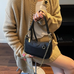 Litchi pattern black underarm bag with gold chain strap and pink strawberry charm