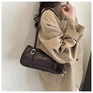Detailed view of coffee brown shoulder bag with gold zipper and smooth faux leather
