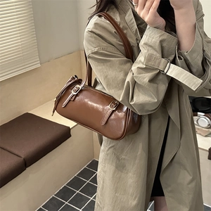 Vintage brown glossy cylinder baguette bag with leather straps and metal buckles