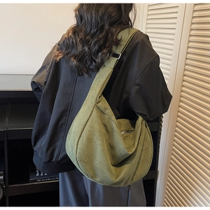 Detail of olive green large crescent crossbody bag with adjustable silver buckle and soft drape