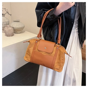 Detail of caramel patchwork travel tote with smooth leather flap and magnetic buckle