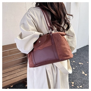 Detail view of large tote bag in brown suede and leather for travel and daily commute