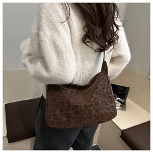 Close-up of leopard print shoulder bag with matte texture and durable strap details