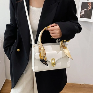 White leather crossbody bag with elegant twilly scarf handle and gold metallic lock clasp