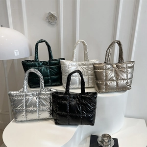 Quilted puffer tote bags in five metallic colors on a minimalist display stand