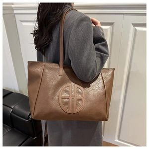 Brown vintage tote bag with HB logo detail and long shoulder strap for daily commuting