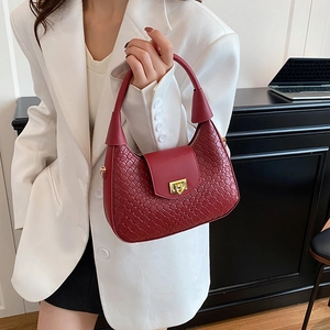 French style red crescent underarm bag with woven texture and gold metal twist lock buckle