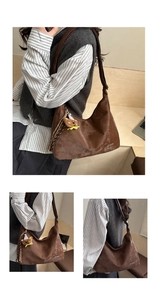 Detail of retro brown tote bag with suede texture and cute teddy bear charm hanging