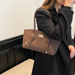 Vintage dark brown quilted leather tote bag with elegant gold metal hardware and slim straps