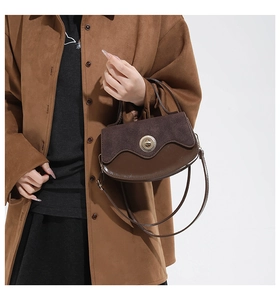 Detailed view of vintage brown patchwork leather handbag with metal turn-lock closure