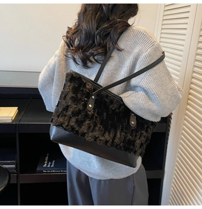 Detail of faux fur tote bag with black faux leather base and long shoulder strap