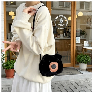 Detail of cute black plush bear shoulder bag with soft faux fur and adjustable strap
