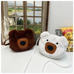 Close-up of cute teddy bear plush shoulder bags in brown and white faux fur texture