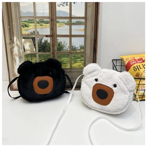 Detailed view of plush bear crossbody bags in black and white faux fur with leather nose