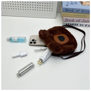 Internal storage detail of plush bear tote bag with phone and cosmetics inside