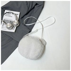 Macro shot of white faux fur crossbody bag with cute plush ears and slim strap