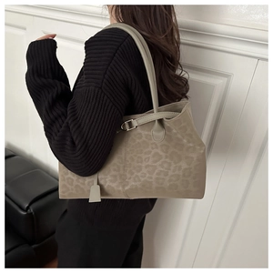 Detail of leopard print tote bag with adjustable metal buckle on shoulder strap