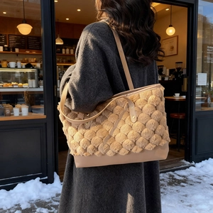 Chic light brown plush bucket bag with quilted texture shown on a stylish model
