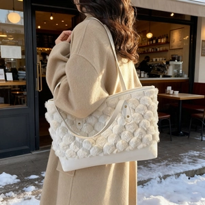 Winter white faux fur tote bag with plush textured weave and leather handles shown outdoor