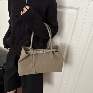 Retro taupe leopard print tote bag with gold buckle and slim straps worn by a model