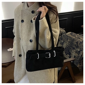 Close-up of matte black vintage shoulder bag with silver buckles and elegant dual straps