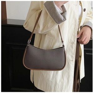 Detail view of a vintage baguette bag with cross-pattern leather and silver rings