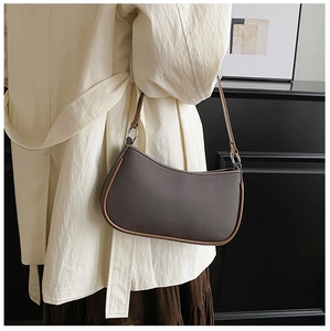 Detail of vintage retro hobo bag with silver ring hardware on a stylish model