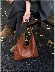 Detailed macro view of vintage brown leather texture and logo on the autumn tote bag