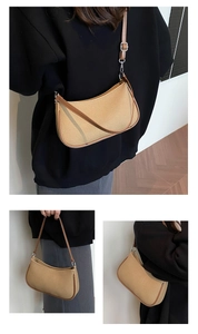 Detail of khaki fabric dumpling bag with brown leather trim and adjustable shoulder strap