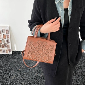 Brown leather handbag with embossed crown pattern and woven texture for women