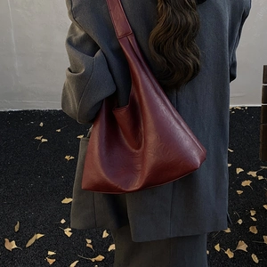 Deep red leather tote bag for women showing a large capacity shoulder design