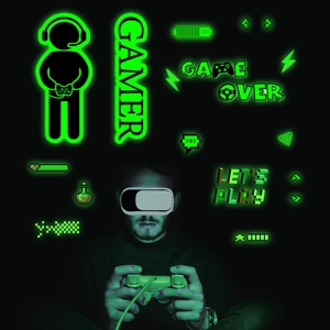 Macro detail of glow-in-the-dark pixel game wall stickers with Gamer and neon icons