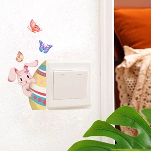 Detail view of colorful Easter bunny and butterfly stickers applied near a wall switch