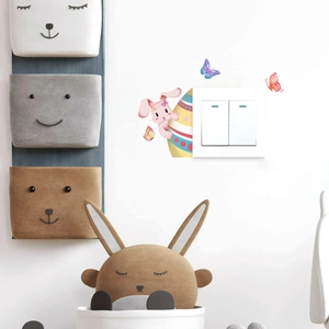Detail of Easter bunny and colorful egg wall stickers around a white light switch